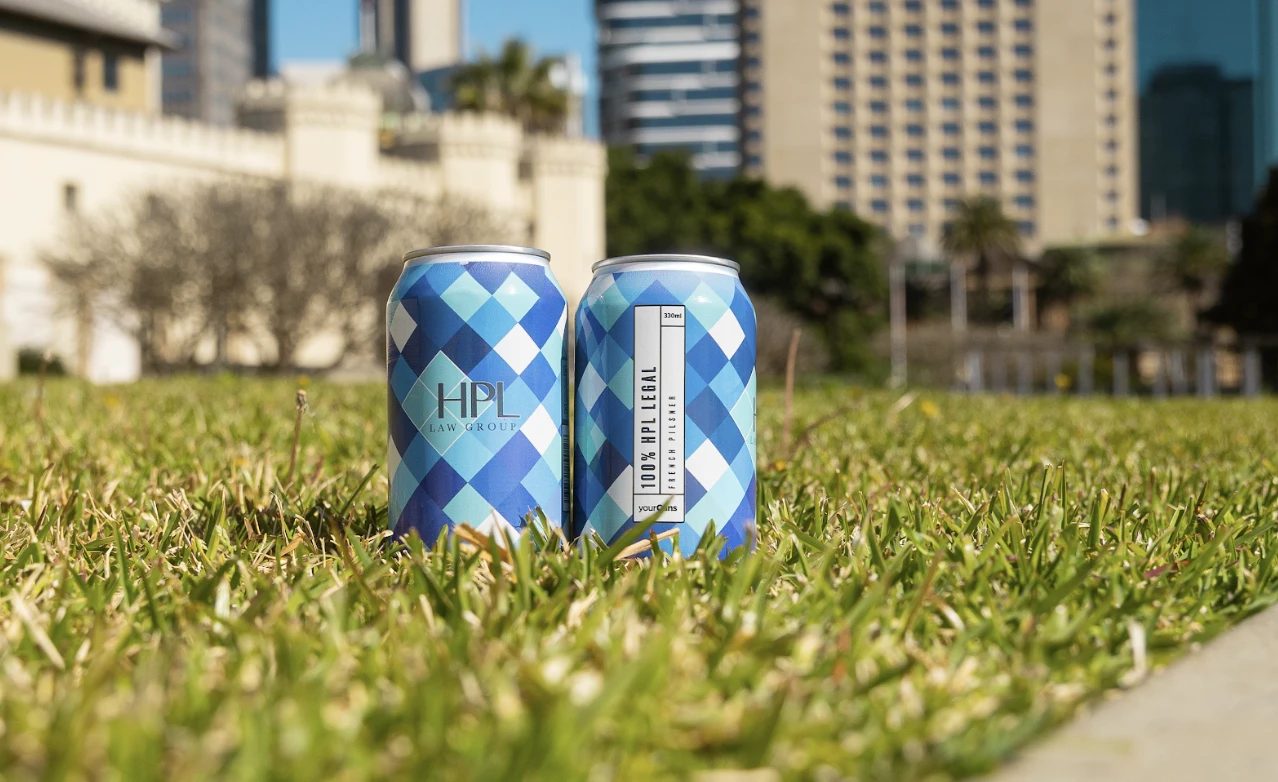 HPL Law Group branded cans on grass in the city